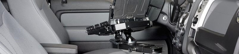 A laptop mount and docking cradle installed in a patrol vehicle