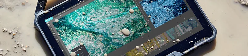 A rugged tablet running mapping software, resting on gravel